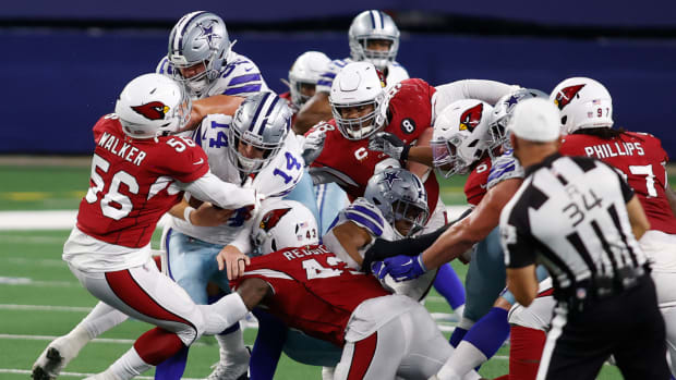 Oct 19, 2020; Arlington, Texas, USA; Dallas Cowboys quarterback Andy Dalton (14) is sacked by Arizona Cardinals outside linebacker Haason Reddick (43) and linebacker Reggie Walker (56) in the third quarter at AT&T Stadium. Mandatory Credit: Tim Heitman-USA TODAY Sports  